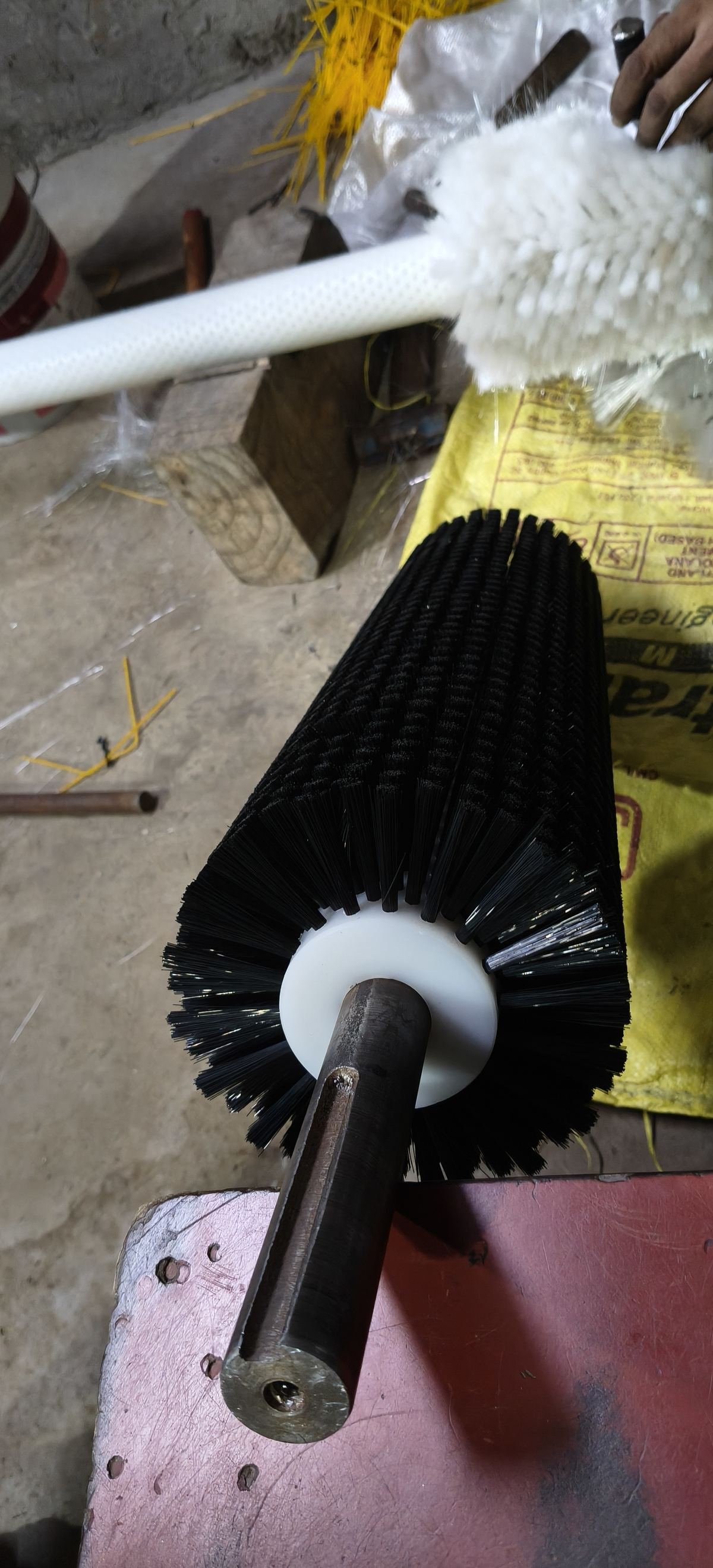 Black tufted centre brush roller with white hub and steel drive shaft