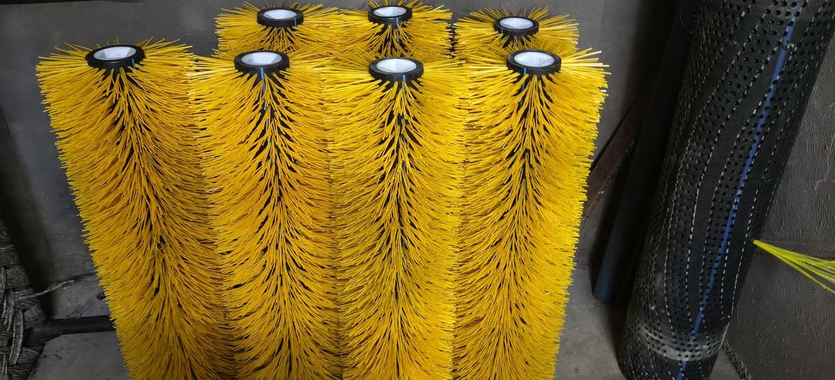 Yellow centre brushes beside a perforated tube core ready for tufting