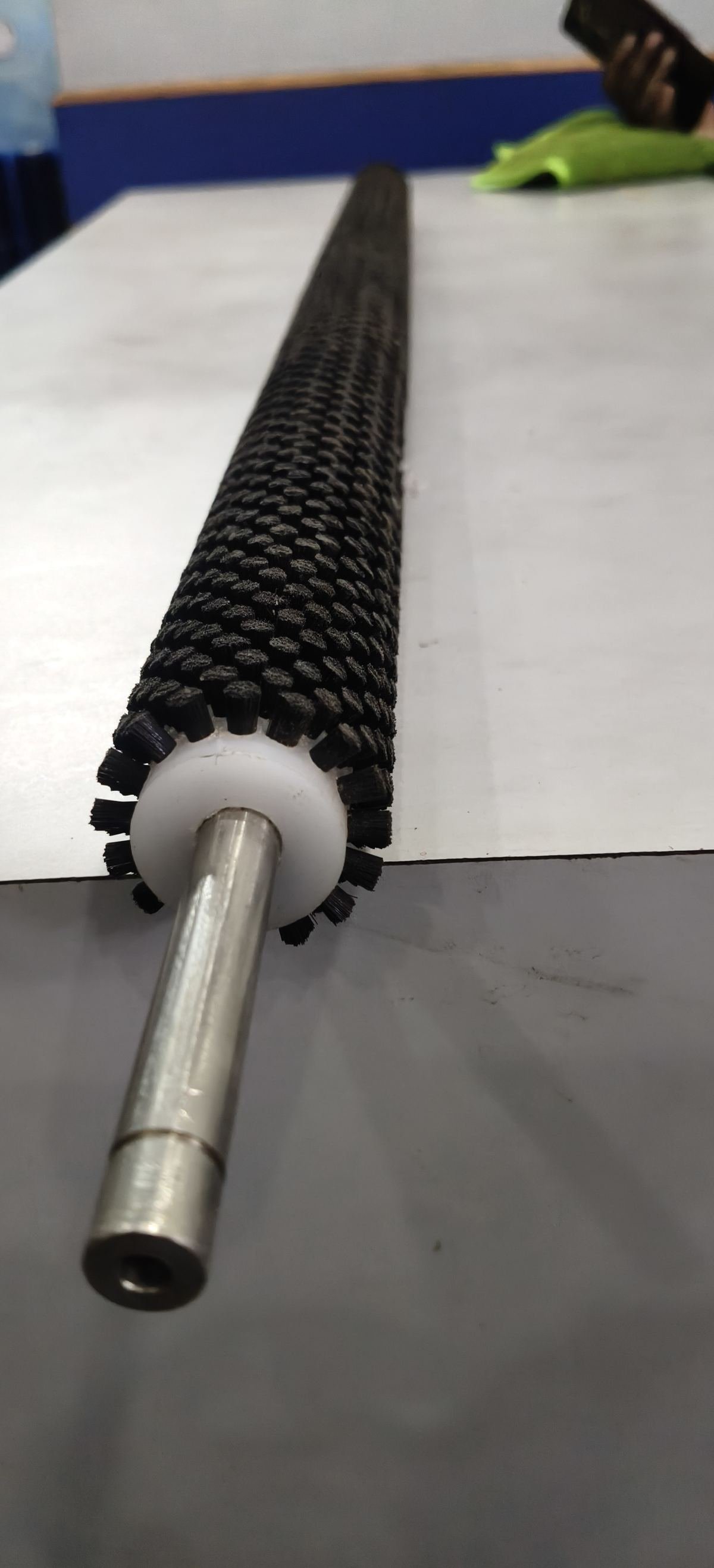Mandrel shaft roller brush with machined steel shaft and bush